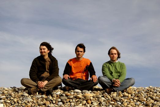 three casual young men at the beach