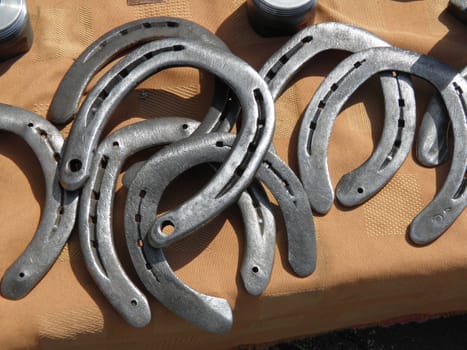 a bunch of horseshoes for sale on a counter