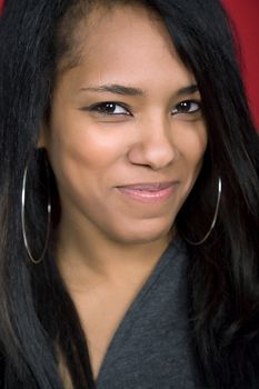 young beautiful woman closeup portrait, on a red background