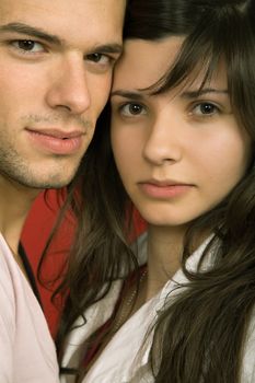 young couple together portrait on red background
