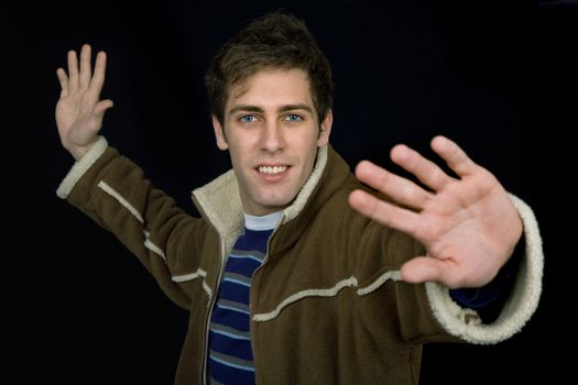 young casual man against a black background