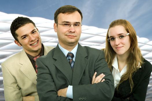 young business team with a modern building behind