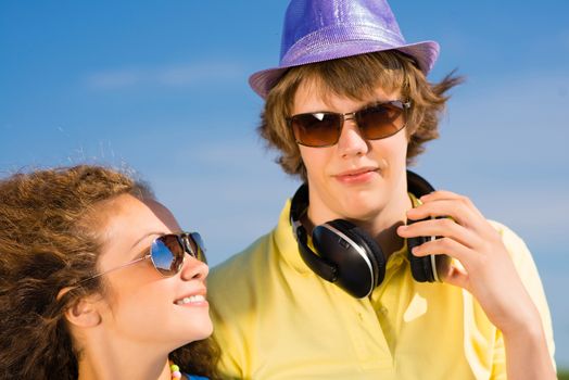 young couple standing on the road, having fun with friends