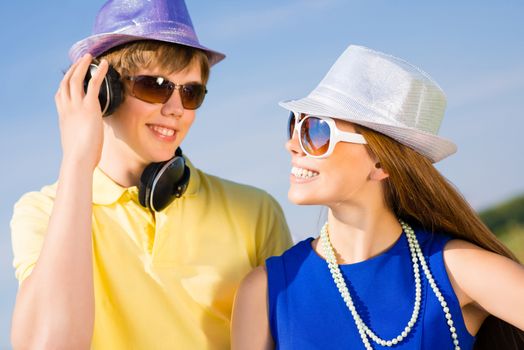 young couple standing on the road, having fun with friends