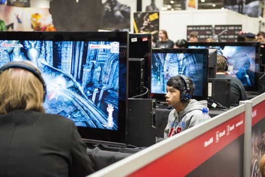 LONDON, UK - OCTOBER 26: Players testing previews of games to be released in 2014, inside the exhibition hall at the Excel Centre's Comicon. October 26, 2013 in London.