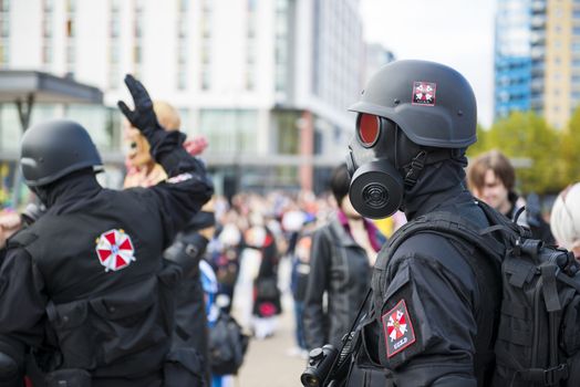 LONDON, UK - OCTOBER 26: Cosplayers dressed as Umbrella Corporation's soldiers from the film Resident Evil in the Comicon at the Excel Centre's MCM Expo. October 26, 2013 in London.