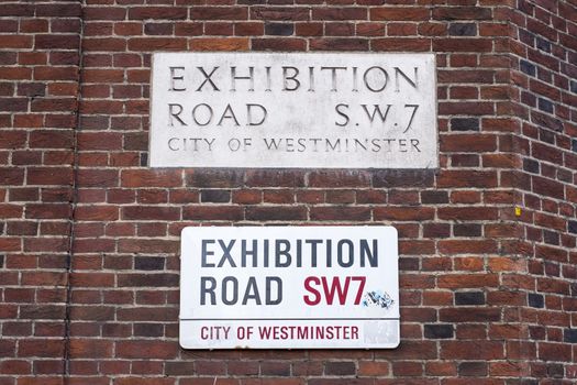 An old and a new version of road signs for Exhibition Road in London, UK