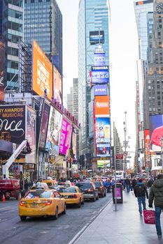 NEW YORK, US - NOVEMBER 24: Queue of famous New York yellow taxis in busy Times Square. November 24, 2013 in New York.