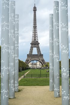 PARIS, FRANCE - OCTOBER 20: The Eiffel tower framed by obelisks of the mur de la paid, in Champ de Mars. October 20, 2013 in Paris.