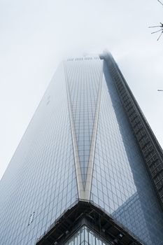 NEW YORK, US - NOVEMBER 22: Low angle shot of new World Trade Centre building engulfed by low hanging clouds. November 22, 2013 in New York.