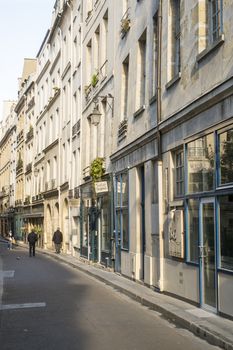 Paris, FRANCE - OCTOBER 18: Long street in Paris with pedestrians in the background. October 18, 2013 in Paris.
