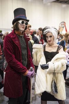 LONDON, UK - OCTOBER 26: Cosplayers dressed as Charlie from the chocolate Factory and Cruella de Vil from 101 Dalmatians for the Comicon at the Excel Centre's MCM Expo. October 26, 2013 in London.