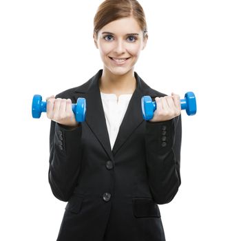 Beautiful and young business woman lifting weights and smiling, isolated over white background