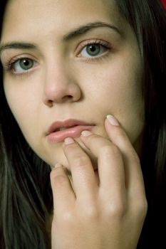 young beautiful pensive woman close up portrait