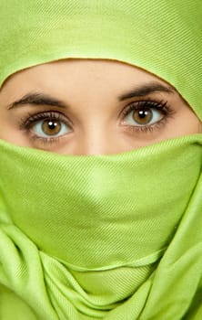 young woman close up portrait with a green veil