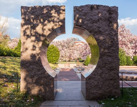 Entrance to Enid A Haupt garden through large granite Moon Gate entranceway in Washington DC