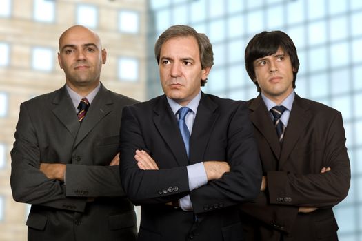 team of three business men standing pensive