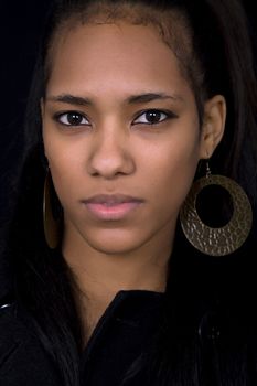 young beautiful woman close up portrait, on black background