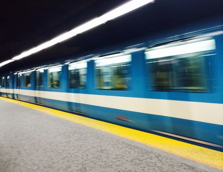Montreal subway station and train with motion blur.