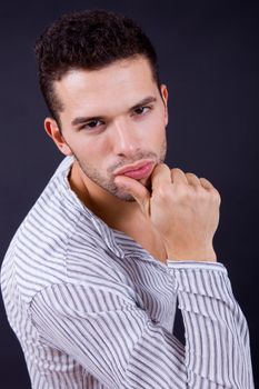 young casual man portrait on a black background