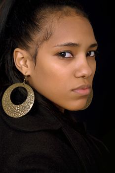 young beautiful woman close up portrait, on black background