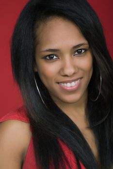 young beautiful woman closeup portrait, on a red background