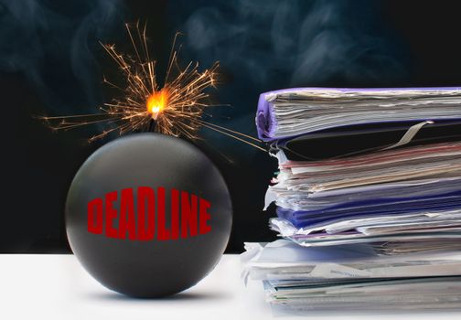 Exploding bomb labeled deadline next to a stack of papers