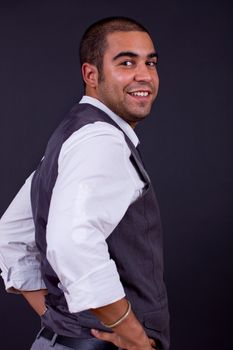 young happy businessman, on a black background