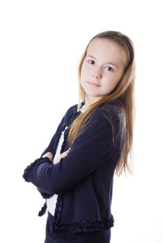 Serious schoolgirl in uniform lookig stright isolated on white