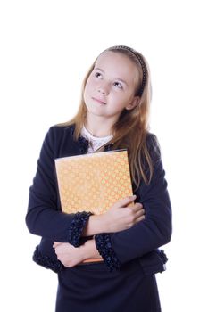 Pansive schoolgirl in uniform and books lookig up isolated on white