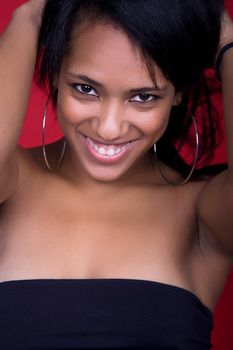 young beautiful woman closeup portrait, on a red background