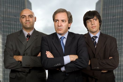 team of three business men standing pensive