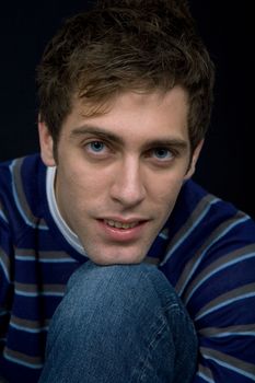 young casual man against a black background