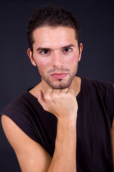 young casual man portrait on a black background