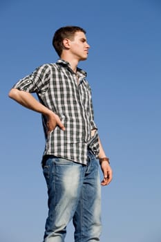 young casual man with the sky as background