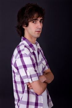 young casual man against a black background