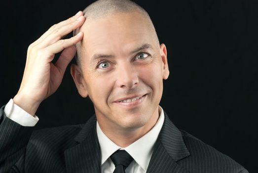 Close-up of a happy bald man feeling his shaved head.