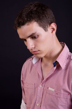 young casual man against a black background