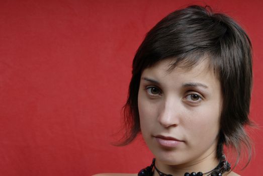 young woman portrait isolated on red background