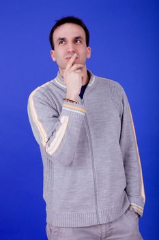 an casual young man portrait over a blue background