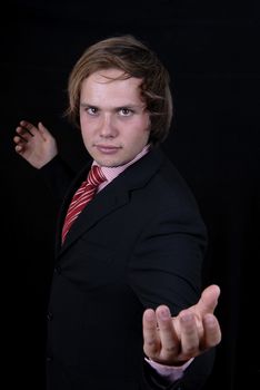 young business man portrait on black background