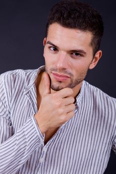 young casual man portrait on a black background