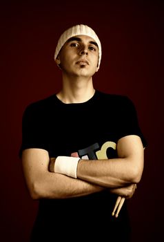 young serious man portrait with hat, studio picture