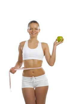 image of a young attractive woman with measuring tape and green apple