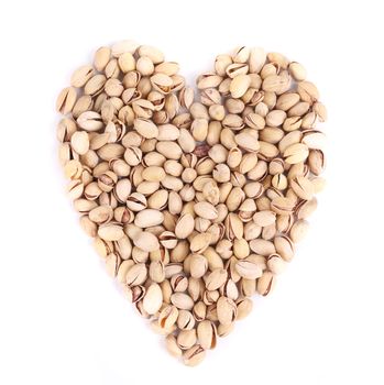 Heart shape of fresh pistachios. Isolated on a white background.