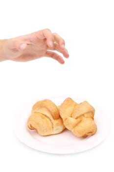 Hand taking croissant. Isolated on a white background.