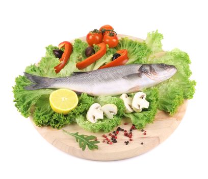 Fresh seabass on platter with lettuce. Isolated on a white background.