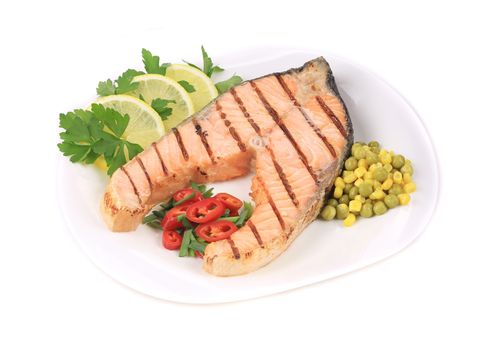 Grilled salmon filler with vegetables. Isolated on a white background.