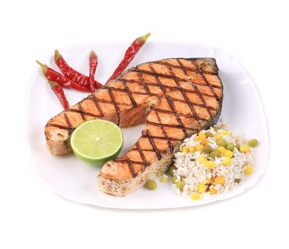 Grilled salmon steak with vegetables on plate. Isolated on a white background.