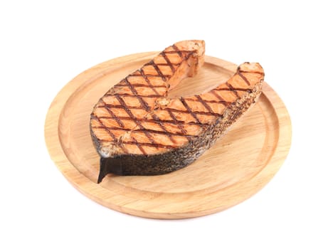 Grilled salmon steak on platter. Isolated on a white background.